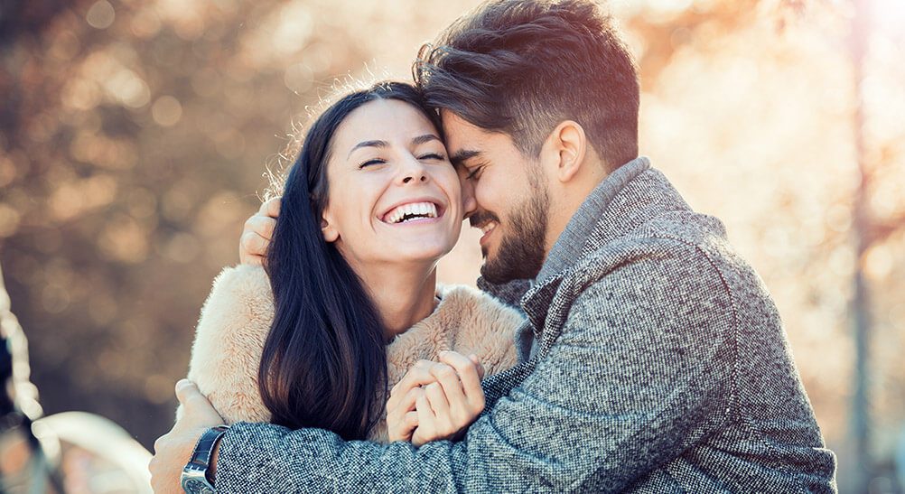 Happy couple embrace after hearing about lottery win