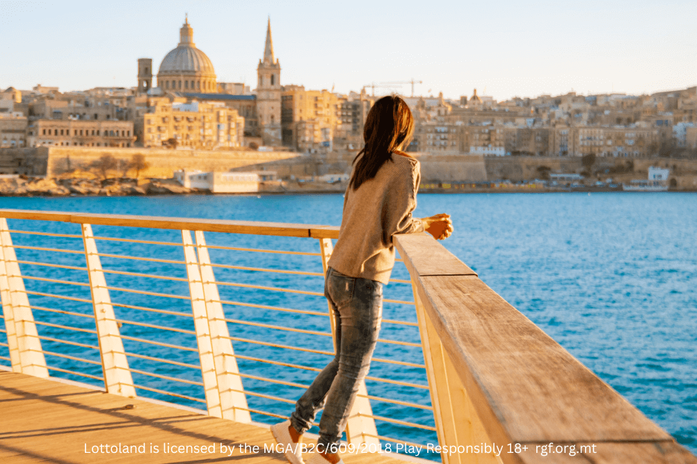 A woman with her back to the camera, looking out over a harbour in Malta. Perhaps she is thinking about how agonising it would be to miss out on a jackpot by just one number!
